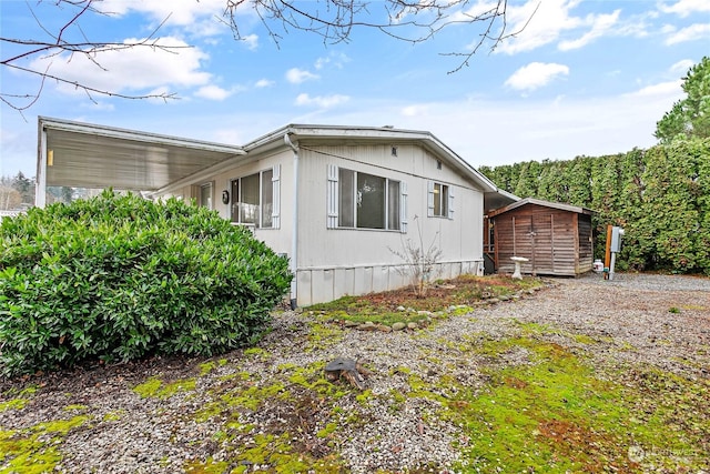 view of property exterior featuring a shed