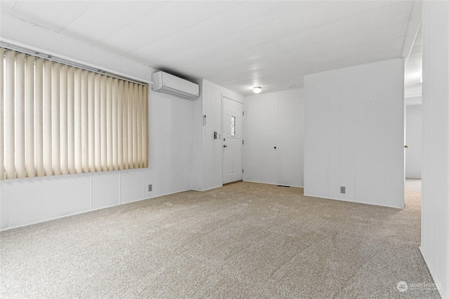 carpeted spare room with an AC wall unit