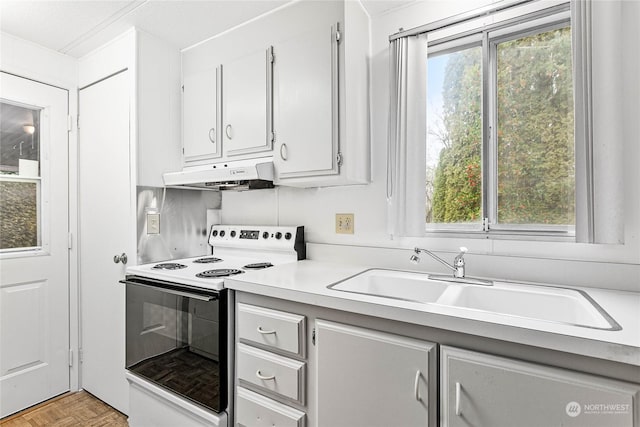 kitchen with sink, range with electric stovetop, white cabinets, and light parquet flooring