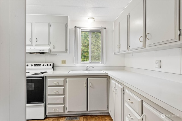 kitchen featuring white electric range oven, sink, and white cabinets