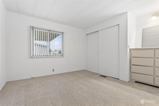 unfurnished bedroom featuring carpet floors and a closet