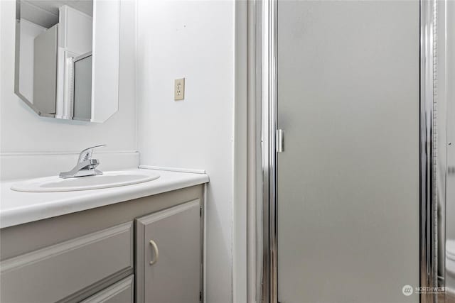 bathroom with vanity and walk in shower