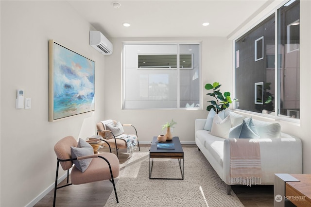 living room featuring wood-type flooring and a wall mounted air conditioner