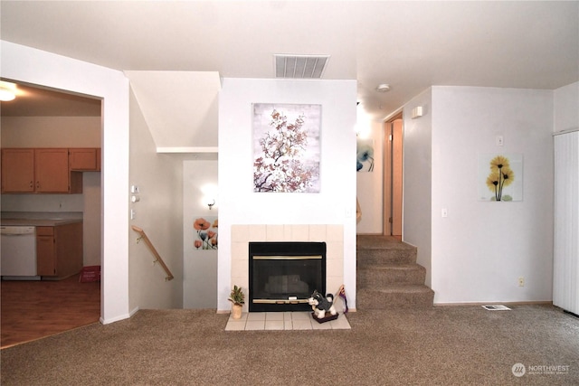 living room with a tiled fireplace and light carpet