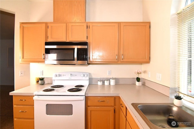 kitchen featuring sink and white range with electric stovetop