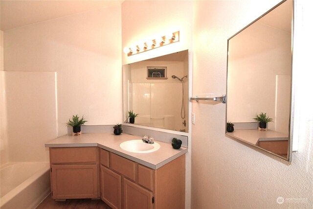 bathroom featuring tub / shower combination and vanity