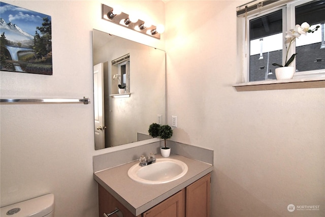 bathroom with toilet and vanity