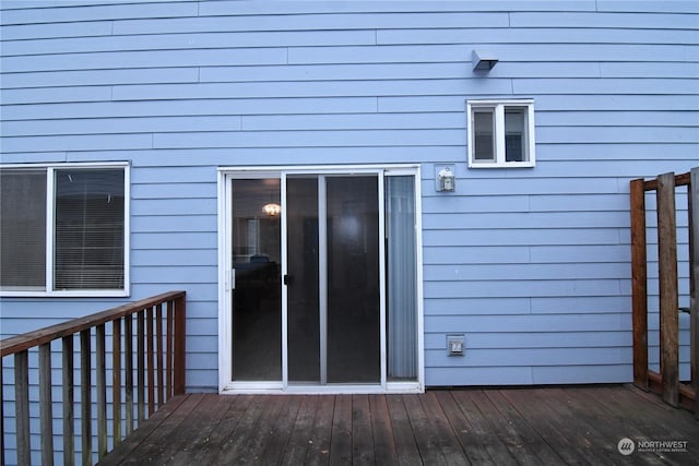 view of exterior entry featuring a wooden deck