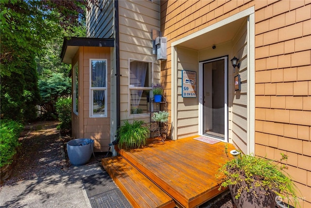 view of exterior entry featuring a deck