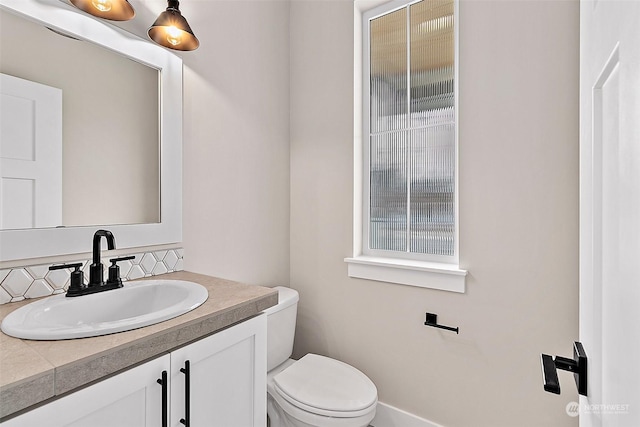 bathroom featuring vanity and toilet