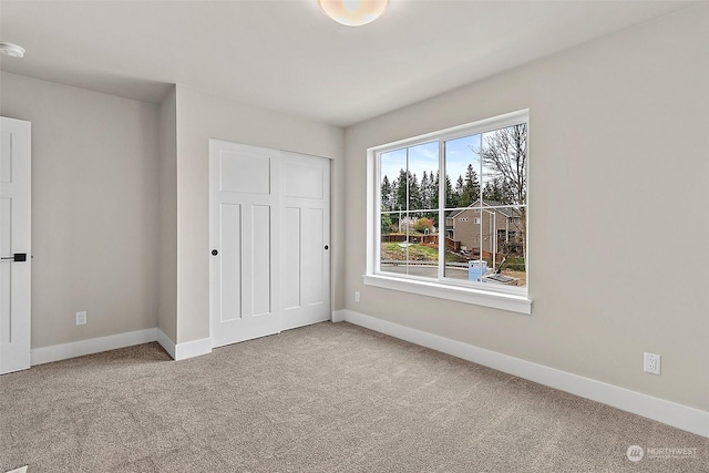 unfurnished bedroom with carpet and a closet