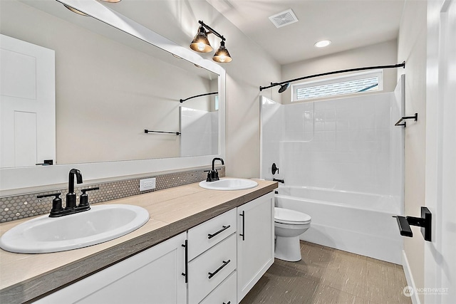 full bathroom with vanity, toilet, decorative backsplash, and bathtub / shower combination