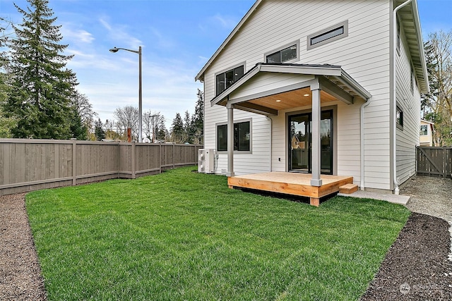 back of property featuring a lawn and a deck