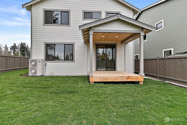 back of property featuring a yard and a deck