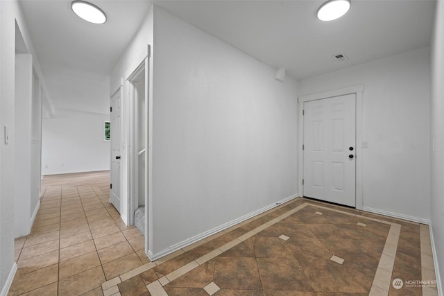 corridor featuring tile patterned flooring