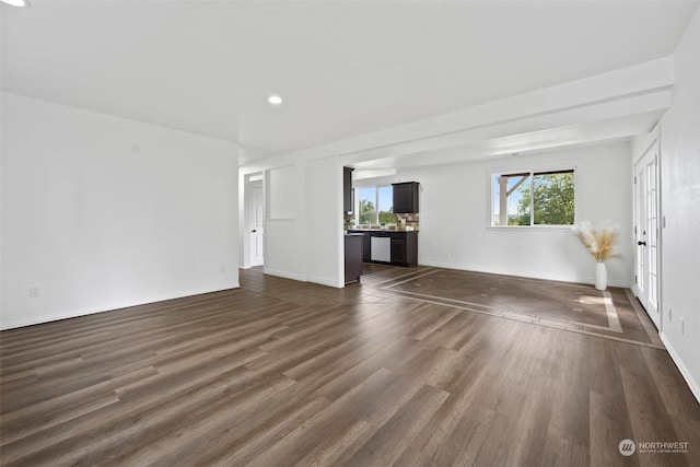 unfurnished living room featuring dark wood-type flooring