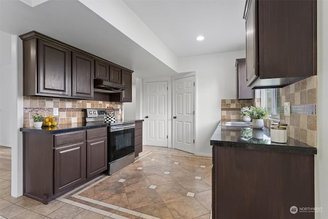 kitchen featuring stainless steel range with electric stovetop, light tile patterned floors, decorative backsplash, and dark brown cabinetry