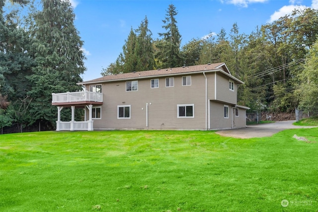 back of house featuring a yard and a deck