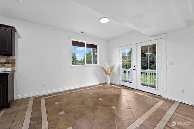 interior space with french doors and dark tile patterned floors