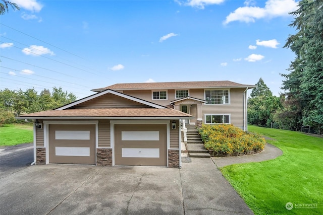 view of front of property with a garage and a front lawn