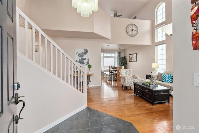 entryway featuring hardwood / wood-style flooring, a high ceiling, and ceiling fan