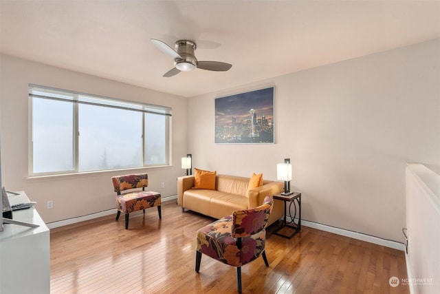 living area with ceiling fan and light hardwood / wood-style flooring