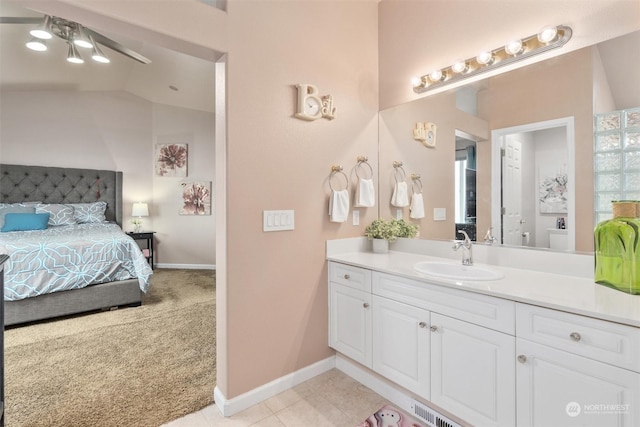 bathroom featuring ceiling fan, vanity, and lofted ceiling