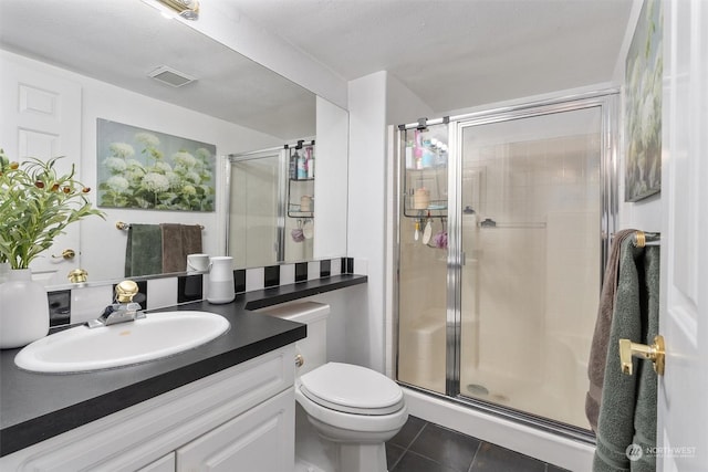 bathroom with toilet, a shower with door, vanity, and tile patterned flooring