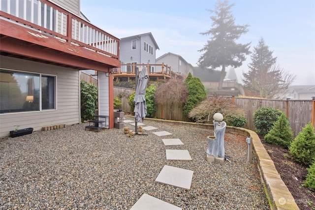 view of yard with a patio area and a wooden deck