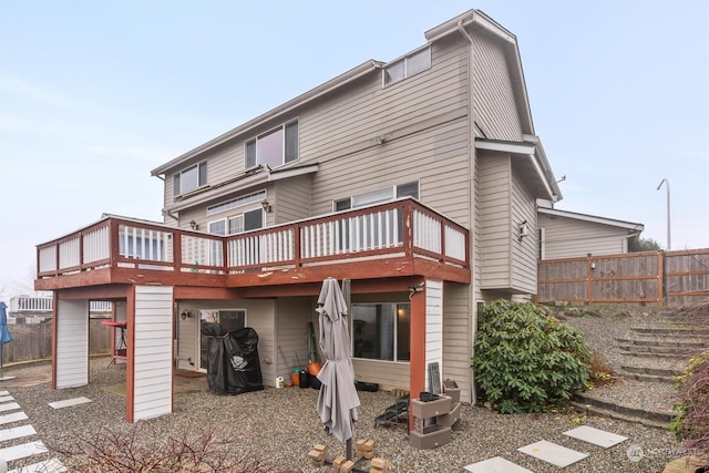 back of property featuring a wooden deck