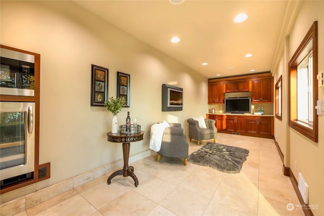 living room featuring light tile patterned floors and beverage cooler