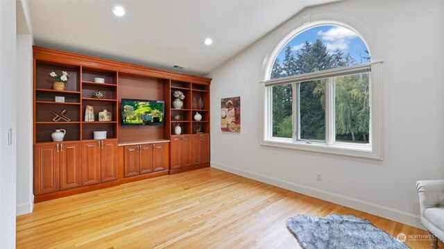 sitting room with light hardwood / wood-style floors and lofted ceiling