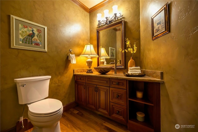 bathroom featuring hardwood / wood-style floors, vanity, toilet, and crown molding