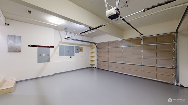 garage with electric panel and a garage door opener