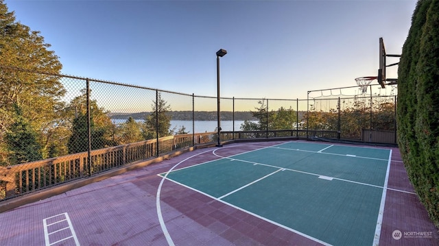 view of sport court with a water view