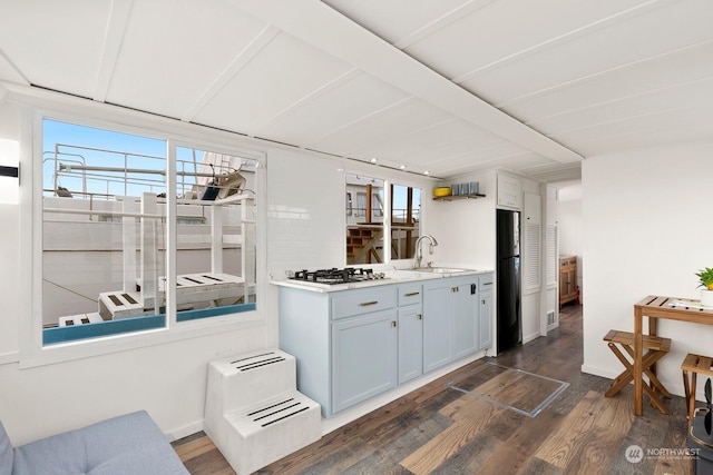 kitchen featuring sink, refrigerator, stainless steel gas cooktop, and dark wood-type flooring