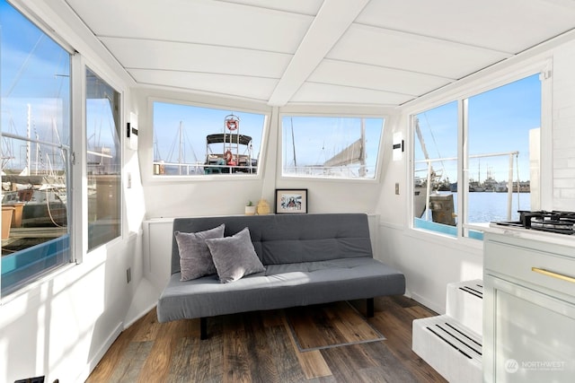 sunroom featuring a water view