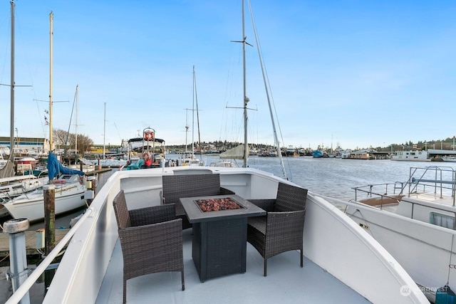 dock area with an outdoor fire pit and a water view