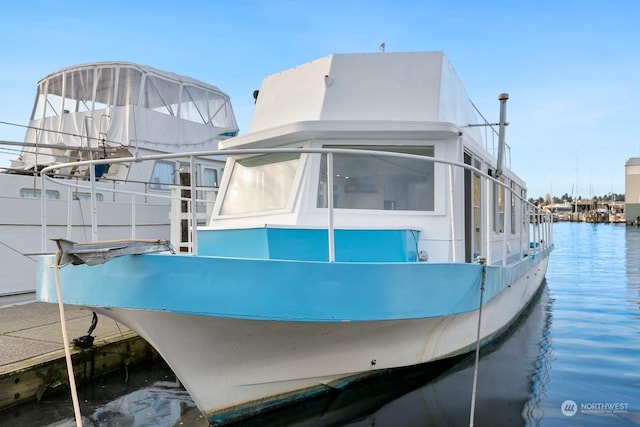 exterior space featuring a dock and a water view