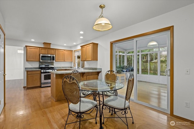 dining space featuring light hardwood / wood-style floors and sink