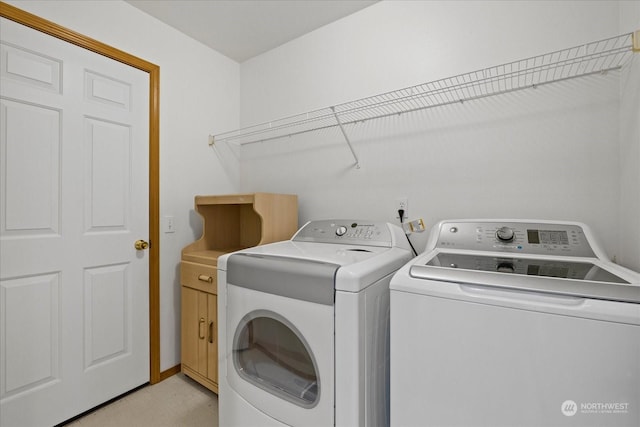 laundry area featuring cabinets and separate washer and dryer