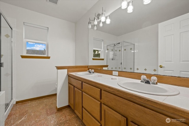 bathroom with vanity and a shower with shower door