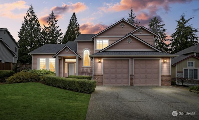 view of front of property featuring a garage and a lawn