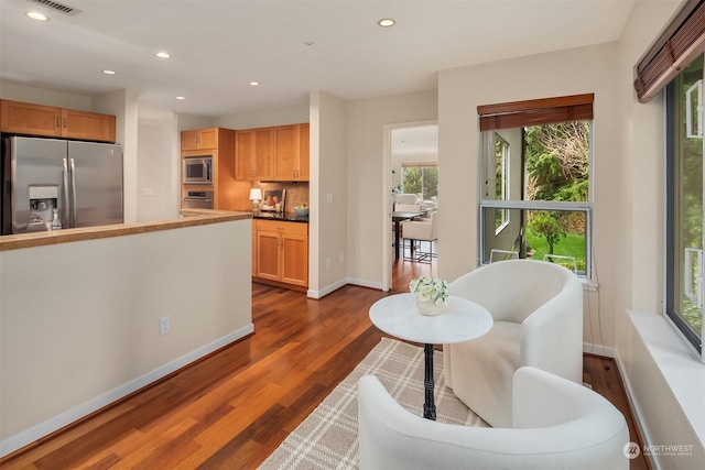 kitchen with tasteful backsplash, stainless steel appliances, and dark hardwood / wood-style floors