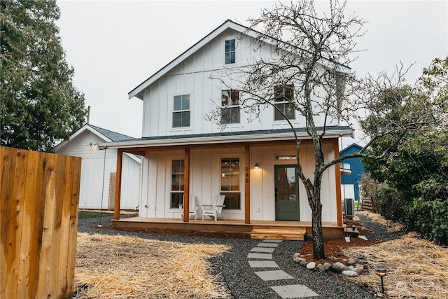 back of house with covered porch and central AC unit