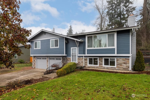 raised ranch with a front yard and a garage