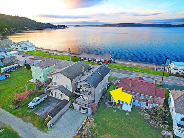 aerial view at dusk with a water view