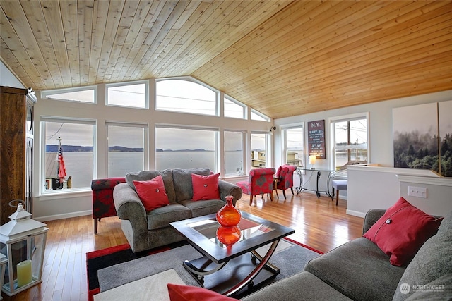 living room with light hardwood / wood-style floors, vaulted ceiling, plenty of natural light, and wooden ceiling