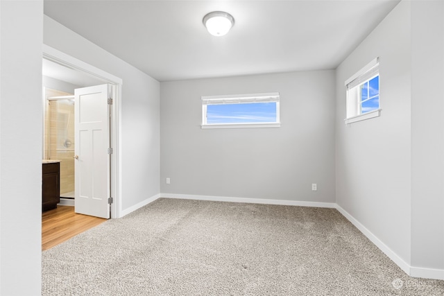 carpeted spare room featuring a wealth of natural light