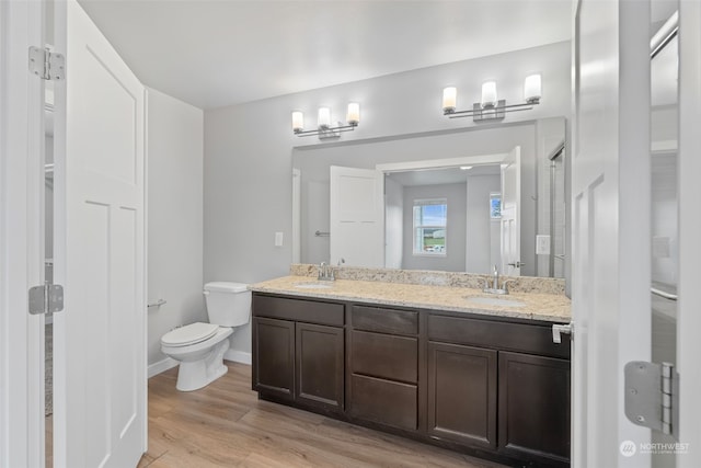 bathroom featuring toilet, vanity, and hardwood / wood-style flooring